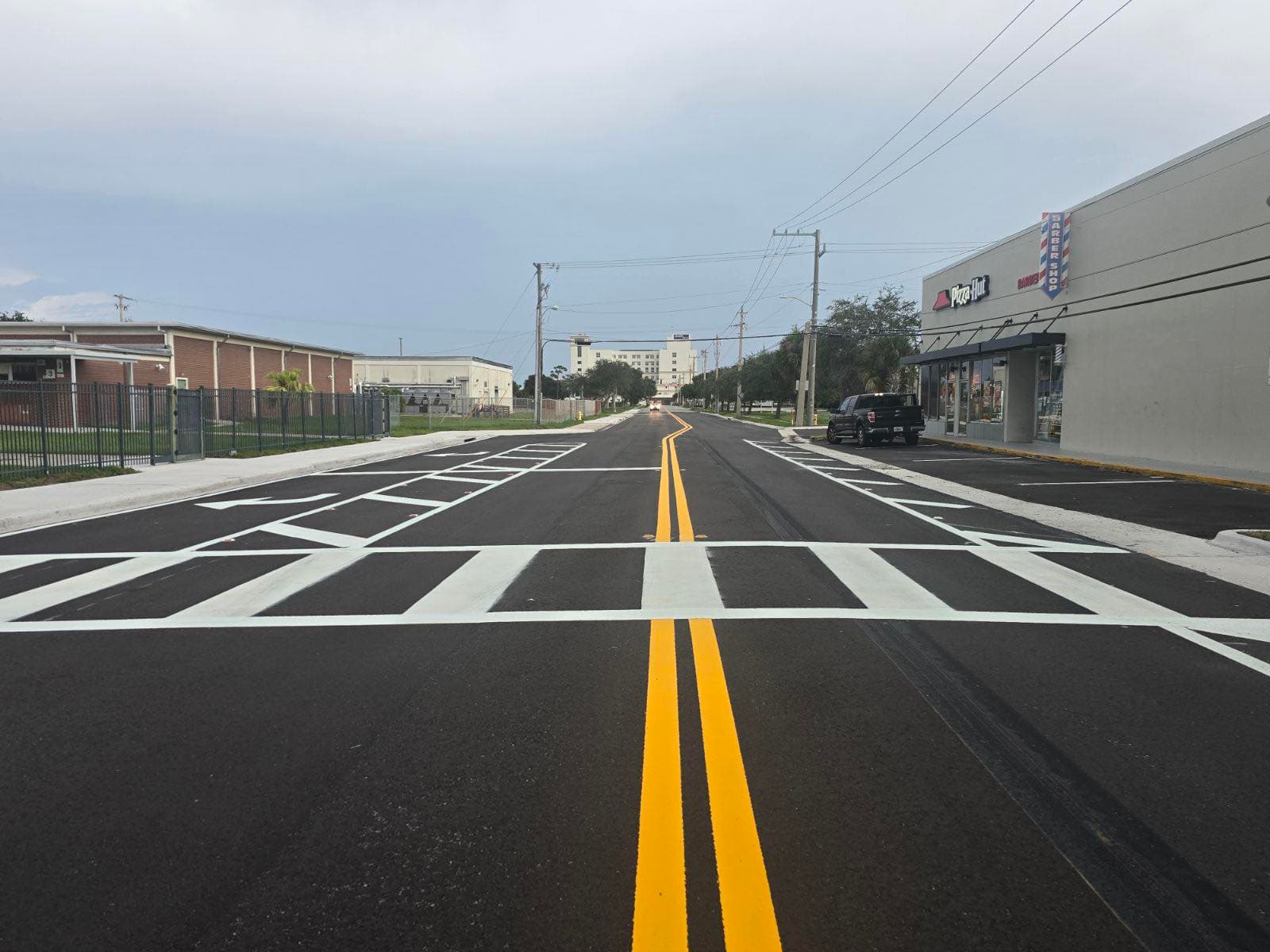 Freshly striped street and parking area with bright yellow and white markings in Florida